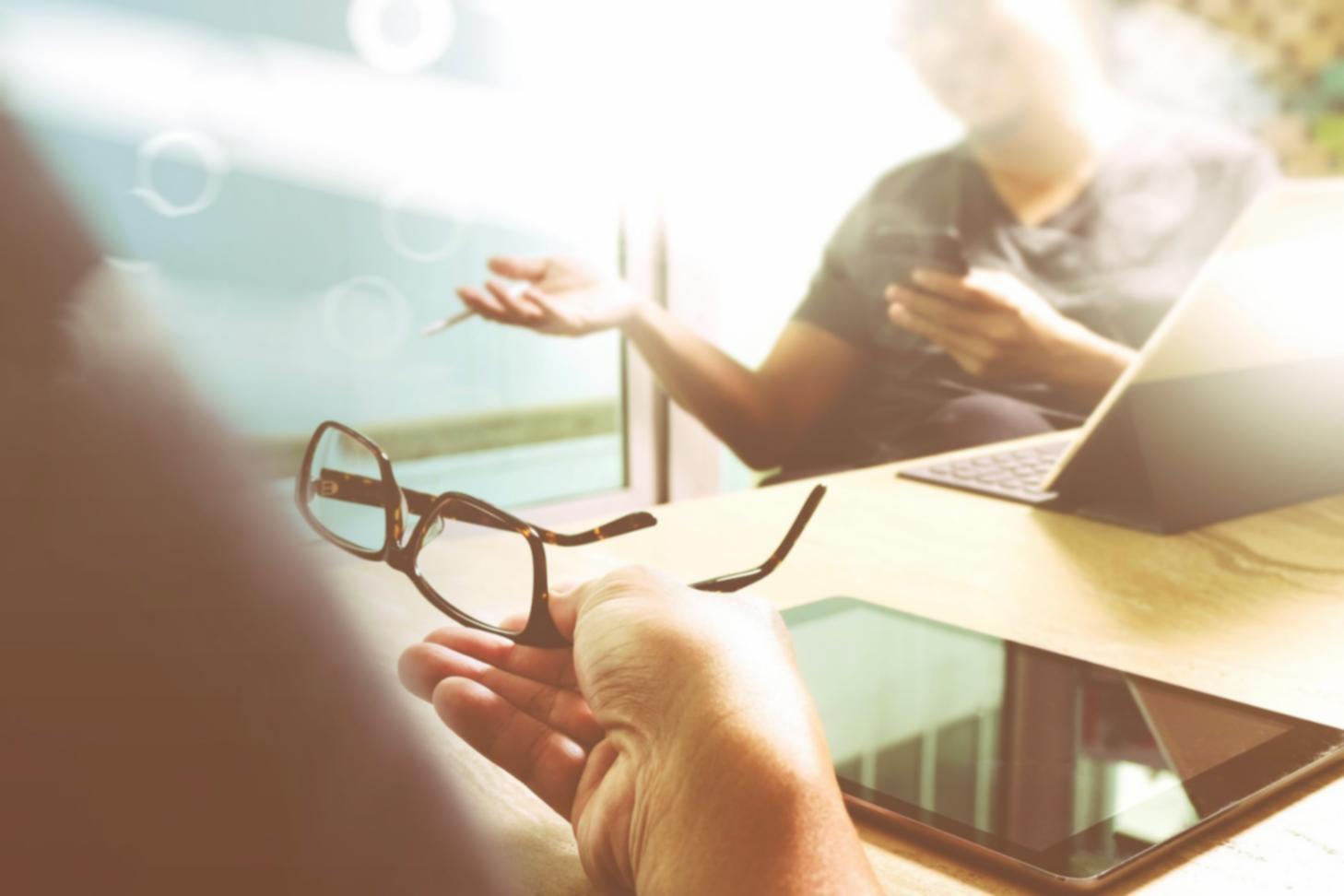 Students collaborating on blockchain development project with laptops and whiteboard diagrams